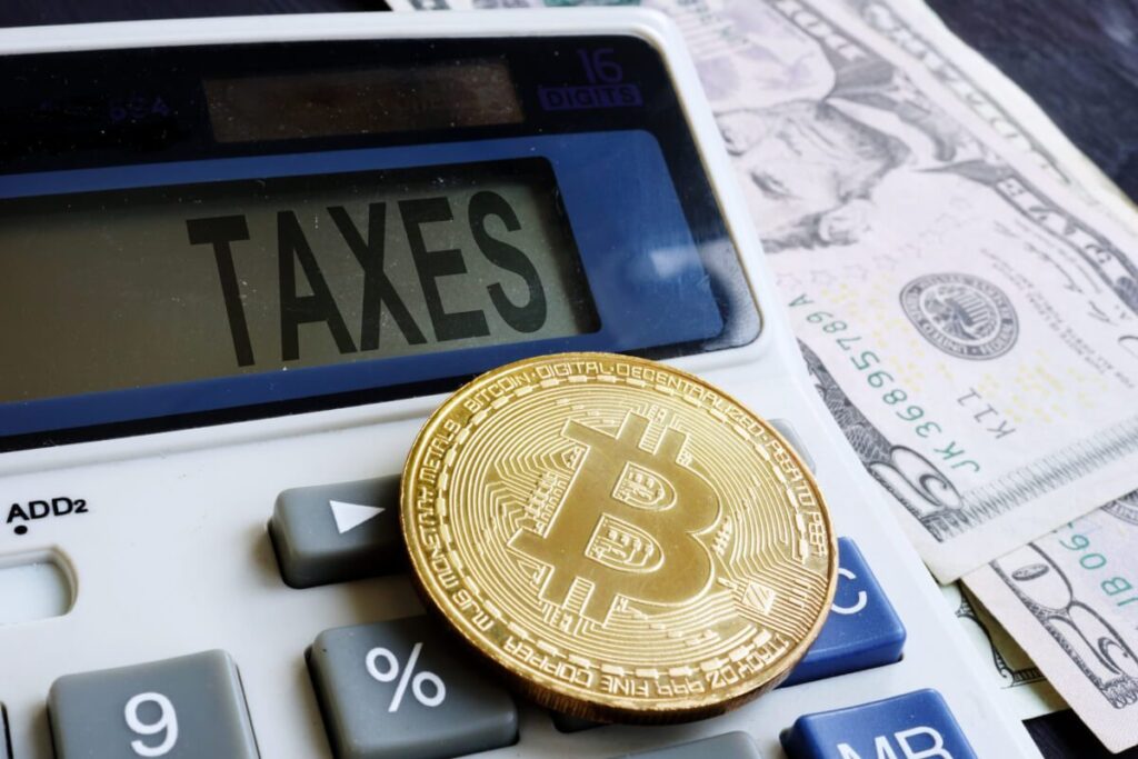 Bitcoin logo and Calculator showing Taxes